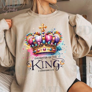 May include: A beige sweatshirt with a colorful crown and the text "Daughter of the King" and "2 Corinthians 6:18".