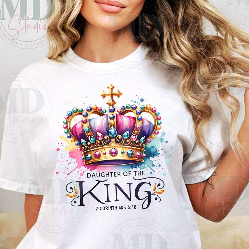 May include: White t-shirt with a colorful crown design and the text "Daughter of the King" with the scripture reference "2 Corinthians 6:18".