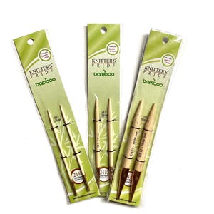 May include: Three packages of bamboo knitting needles. The needles are in different sizes: US 3 (3.25 mm), US 8 (5.00 mm), and US 15 (10.00 mm). The packages are labeled "Knitters Pride Bamboo" and feature a 24K gold plated connector.