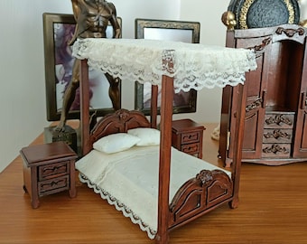 May include: A miniature wooden canopy bed with a white lace canopy, a white bedspread, and two white pillows. The bed is on a wooden floor and there are two small wooden nightstands next to the bed.