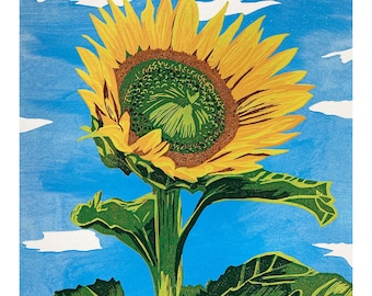 May include: A vibrant yellow sunflower with a large green center blooms against a blue sky with white clouds. The sunflower has large green leaves and a tall green stem.
