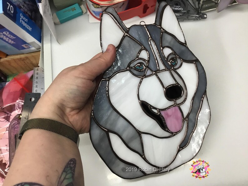 Siberian Husky Suncatcher being held for size reference.