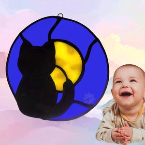 Alphabet Letter- O- shown with a Kitten for October. Letter is made with blue glass, center is yellow and kitten is black.
