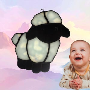 Lamb suncatcher, made with white mottled glass and black. Lamb represents April.