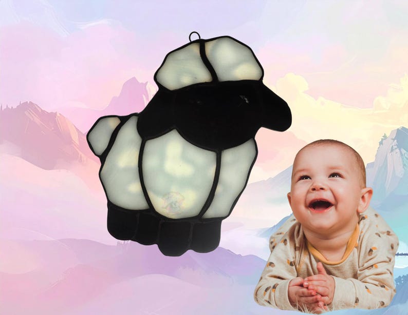 Lamb suncatcher, made with white mottled glass and black. Lamb represents April.