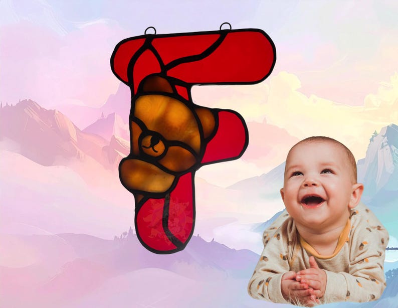 Alphabet letter- F- shown with Bear Cub. Letter is made of red glass while the bear is amber/brown. Bear cub represents February.