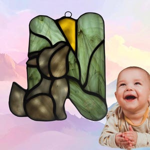 Alphabet Letter- N- show with baby wolf. Letter is made of light green, small center section is yellow (moon) and wolf is made of gray glass. Wolf represents November.