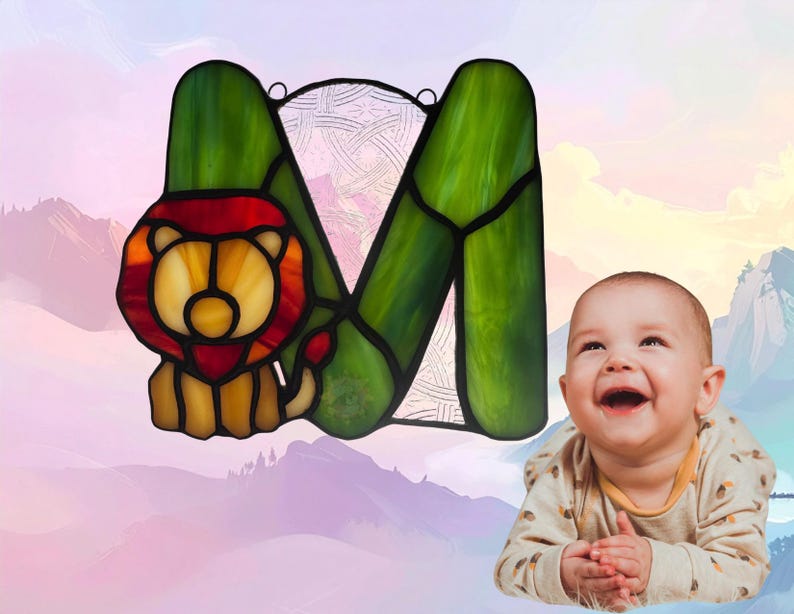 Alphabet letter- M- with Lion. Lion is made with amber glass while M is made with green. Background glass is clear with Celtic design. Lion represents March.