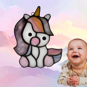 Baby Unicorn suncatcher. Made with white, pink, purple, yellow and blue glass. Unicorn represents June.
