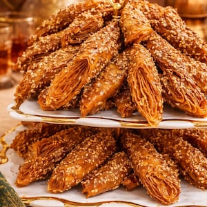 These Authentic Moroccan Chebakia Cookies are a beloved traditional treat enjoyed during Ramadan and Eid celebrations. Also known as chabakia or chbakia, these flower-shaped moroccan pastries are fried to golden perfection, then coated in honey and sprinkled with sesame seeds. Handmade using a secret family recipe, each batch captures the essence of moroccan tradition. Perfect for iftar gatherings, these halal sweets