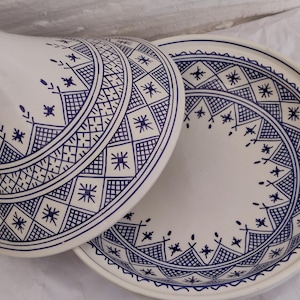 Experience the beauty of Blue Moroccan tagine craftsmanship with this unique piece from Fez pottery. Adorned with geometric star design, this clay tajine pot is perfect for slow-cooked meals and elegant table service. The combination of ceramic tagine body and handcrafted ceramic detail makes it an ideal gift or collector’s item. A true icon of moroccan cooking and North African ceramics.