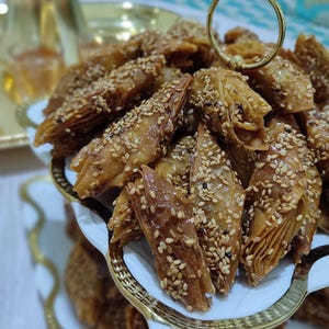 These Authentic Chbakia are the quintessential ramadan sweets found in every Moroccan home during the holy month. Also spelled chebakia, these intricate moroccan pastries are shaped into flowers or butterflies, fried until crisp, then immersed in honey and garnished with sesame seeds. The dough is infused with exotic spices like anise, cinnamon, and saffron, creating a unique flavor profile that defines moroccan tradition. Perfect as eid sweets or daily treats,