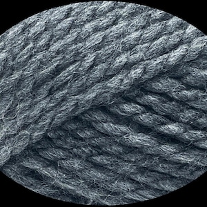 May include: Close-up of a skein of gray yarn. The yarn is thick and textured, with visible strands twisted together. The color is a muted gray, suitable for various knitting or crochet projects.