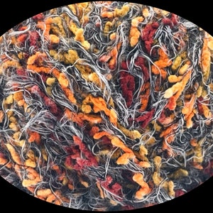 May include: A close-up of a ball of yarn with a mix of black, white, red, orange, and yellow fibers. The yarn is soft and fluffy, and it would be perfect for knitting or crocheting.