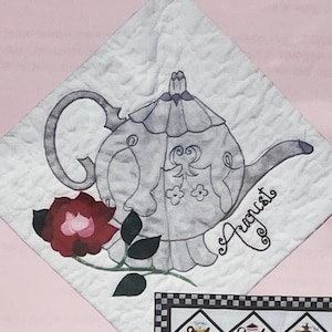 May include: A white teapot with a floral design and a pink rose on a white background with the word "August" written in cursive.