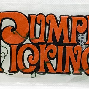 May include: A package of dimensional stickers with the words "Pumpkin Picking" in orange and black. The stickers include a yellow sunflower, green leaves, and pumpkins. A sign reads "Pick Your Own".