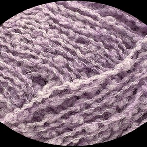 May include: A close-up of a skein of soft, purple yarn with a fuzzy texture.