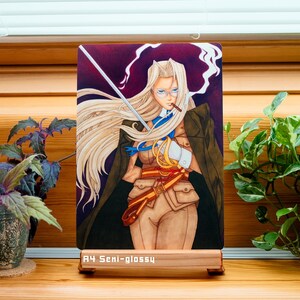 May include: A watercolor illustration of a woman with long blonde hair, wearing a brown jacket, a white shirt, and a brown belt with a gold buckle. She is holding a sword in her right hand and a cigarette in her left hand. The background is a dark purple with smoke.