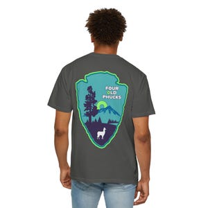 May include: Dark gray t-shirt with a graphic on the back featuring a mountain scene inside a green-outlined arrowhead shape. The graphic includes a tree, a sun, a llama, and the text "FOUR OLD PHUCKS".