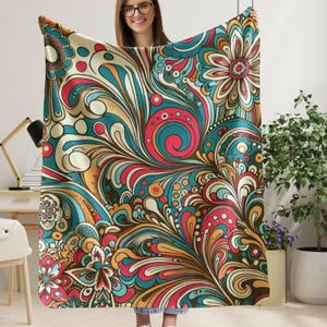 May include: A colourful throw blanket with a swirling, abstract pattern in shades of red, blue, yellow, and brown.