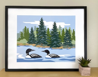 Pode incluir: Uma impressão emoldurada de dois mergulhões preto e branco nadando em um lago azul com uma floresta verde ao fundo.