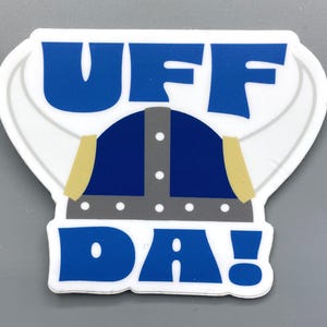 May include: A blue and white sticker with the text "UFF DA!" and a cartoon viking helmet.