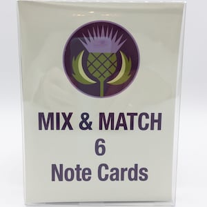 May include: A set of six note cards featuring a purple and green stylized thistle design. The text "MIX & MATCH 6 Note Cards" is printed on the front of the cards.