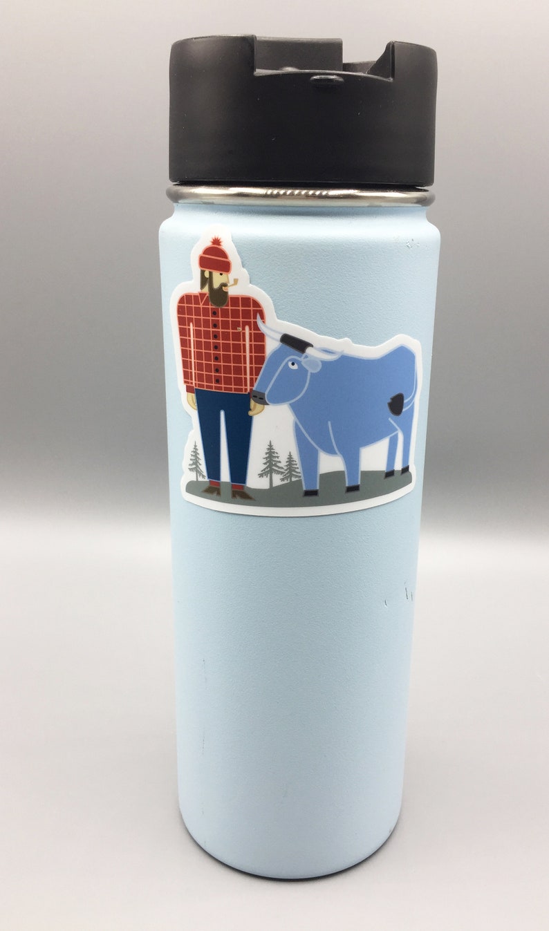 May include: A light blue reusable water bottle with a sticker of a cartoon lumberjack wearing a red and black checked shirt and a blue ox.