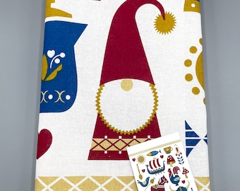 May include: White tea towel with a red and gold Scandinavian folk art design. The design includes a gnome, a horse, a boat, and other traditional motifs. The tea towel has a tag that says "Tea Towel".