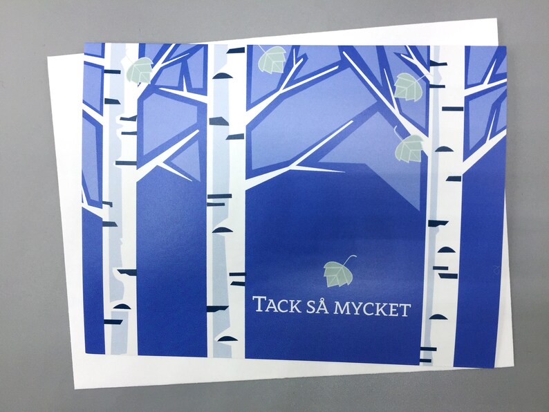 Pu&ograve; includere: Un biglietto blu e bianco con un'immagine stilizzata di betulle e il testo "Tack s&aring; mycket", che si traduce in italiano con "Grazie mille".