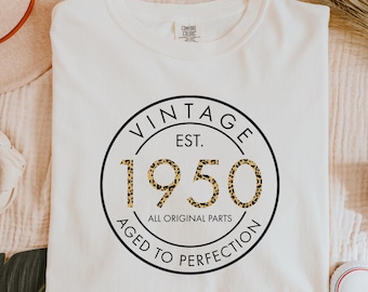 May include: White t-shirt with a black circle graphic that says "Vintage Est. 1950 All Original Parts Aged to Perfection". The 1950 is in a leopard print pattern.