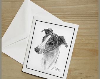 May include: A black and white pencil drawing of a Whippet dog's head and neck. The dog is looking to the left of the image. The drawing is on a white card with a black border. The artist's signature and the year 2013 are in the bottom right corner of the drawing.
