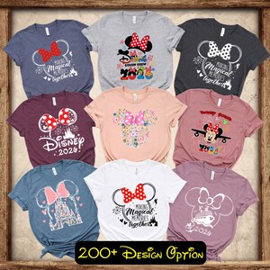 May include: A collection of nine short-sleeved t-shirts in various colors, each featuring a Minnie Mouse-themed design. The designs include bows, the text "Disney 2026", and the phrase "Making Magical Memories Together". The text "200+ Design Option" is also visible.