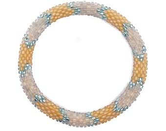 May include: A beaded bracelet with a pattern of light brown and blue beads.