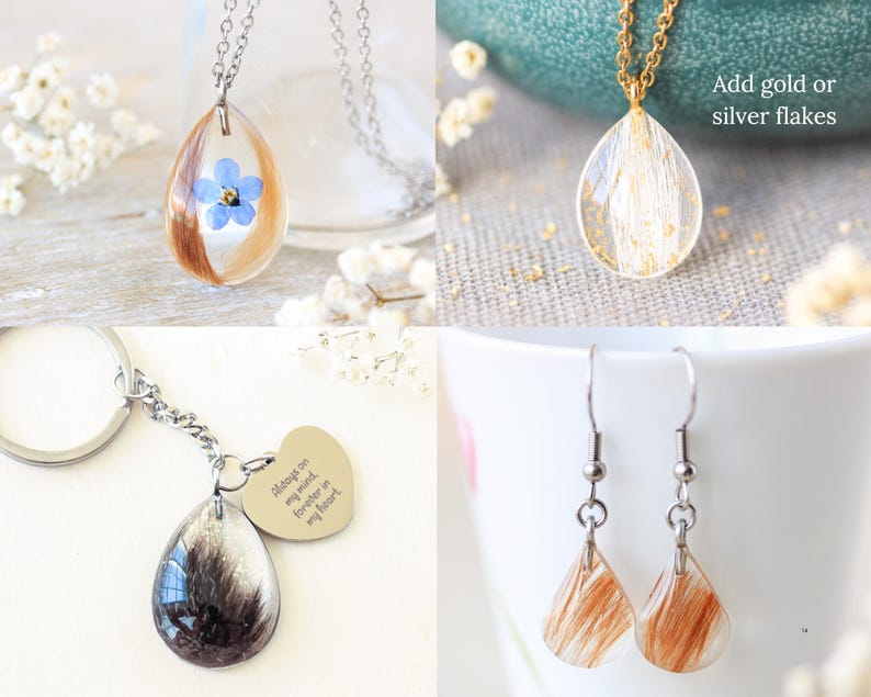 Pode incluir: Uma cole&ccedil;&atilde;o de pe&ccedil;as de joalharia em resina artesanais. Inclui um colar de corrente prateada com um pendente em forma de gota com uma flor azul e cabelo, um colar de corrente dourada com flocos dourados, um porta-chaves e brincos.