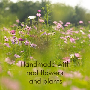 May include: A field of pink and white wildflowers with the text "Handmade with real flowers and plants" in the foreground.