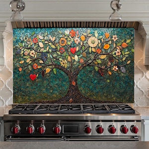 May include: A mosaic tile backsplash featuring a colorful tree with red hearts, flowers, and leaves. The tree is set against a blue and green background. The backsplash is installed above a stainless steel stove with red knobs.