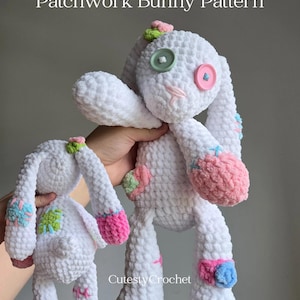 May include: Two white crochet bunny toys with colourful patchwork details. The bunnies have button eyes and pink and blue accents on their feet and ears. The text "Patchwork Bunny Pattern" is at the top, and "Cutest Crochet" is at the bottom.