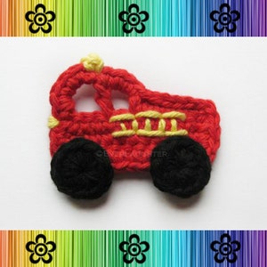 May include: A red crocheted fire truck with black wheels and yellow details. The truck is a small, handmade item.