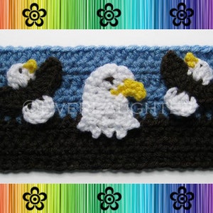 May include: A close-up of a crocheted headband with a blue background and three white crocheted bald eagles. The headband is made with black and blue yarn.