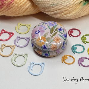 Floral stitch marker tin with stitch markers.