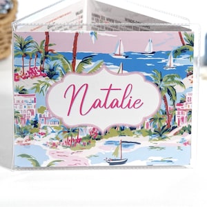 Personalized pink and blue Harbor View mahjong card cover with coastal waterfront homes, palm trees, sailboats, and optional clear sleeve for Large NMJL 2025 2026 card.