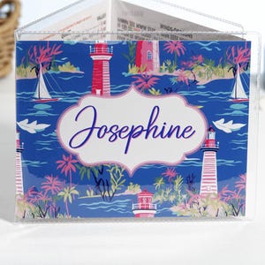 Personalized navy blue and pink beach mahjong card cover featuring lighthouses, sailboats, palm trees, and coastal artwork inside a clear sleeve for large NMJL mahjong cards.