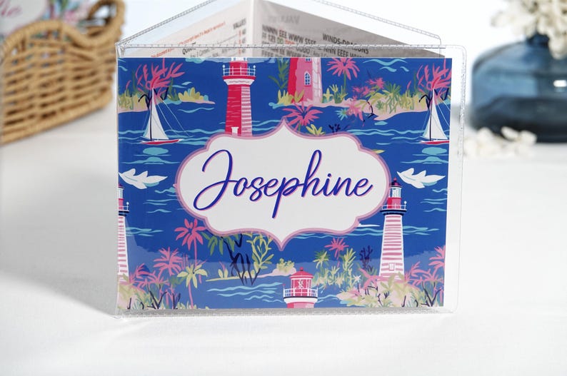 Personalized navy blue and pink beach mahjong card cover featuring lighthouses, sailboats, palm trees, and coastal artwork inside a clear sleeve for large NMJL mahjong cards.