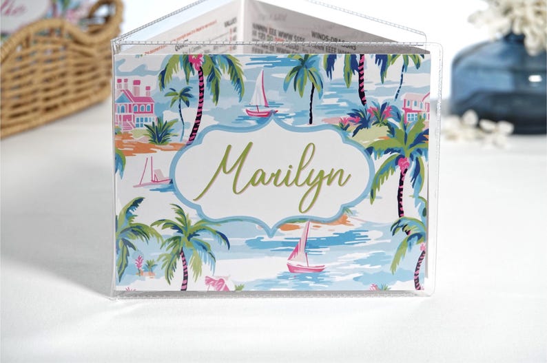 Personalized pink and blue Palm Beach mahjong card cover with palm trees, sailboats, coastal water scene, and optional clear sleeve for Large NMJL 2025 2026 card.