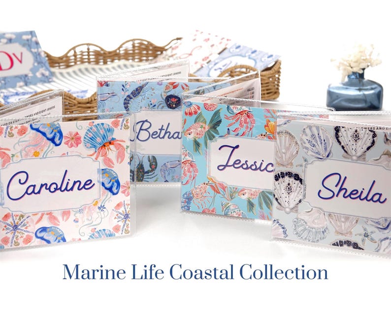 Marine Life Coastal Collection personalized mahjong card covers for Large NMJL cards, featuring ocean beach coastal designs in pastel blue, pink, coral, and aqua, including jellyfish, shellfish, tropical reef, and pearl shells shown in clear protective sleeves.