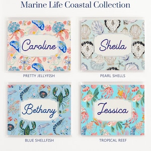 Marine Life Coastal Collection design options for personalized mahjong card covers for Large NMJL cards, showing Pretty Jellyfish, Pearl Shells, Blue Shellfish, and Tropical Reef in pastel blue, aqua, coral, pink, navy, and pearl tones with clear sleeve examples.