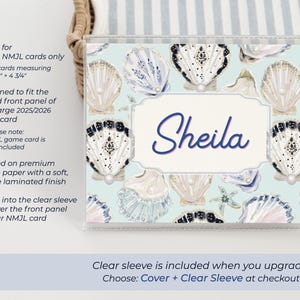 Large NMJL personalized mahjong card cover in the Pearl Shells ocean design, shown inside a clear sleeve with the name Sheila, featuring blue, navy, cream, gold, and pearl seashell artwork on a beach coastal mahjong card holder made for 2025/2026 NMJL cards measuring 6 1/8 x 4 3/4 inches.