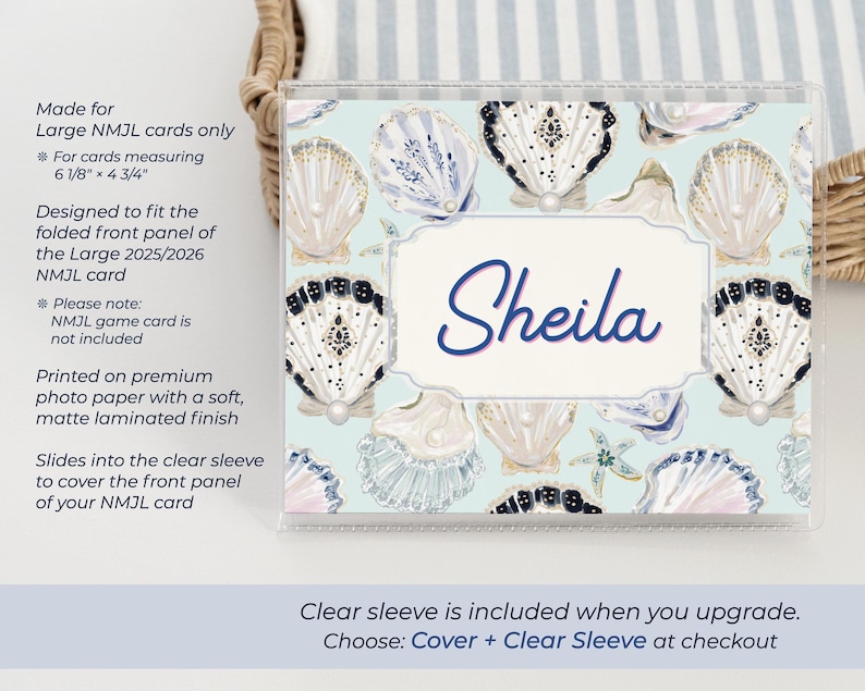 Large NMJL personalized mahjong card cover in the Pearl Shells ocean design, shown inside a clear sleeve with the name Sheila, featuring blue, navy, cream, gold, and pearl seashell artwork on a beach coastal mahjong card holder made for 2025/2026 NMJL cards measuring 6 1/8 x 4 3/4 inches.