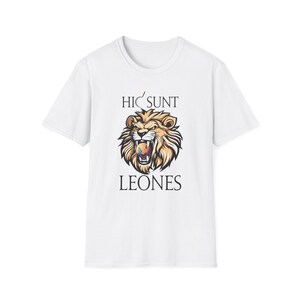 May include: White t-shirt featuring a detailed illustration of a lion's head with an open mouth, showcasing a colorful design within. The text "HIC SUNT LEONES" is printed above and below the lion graphic.